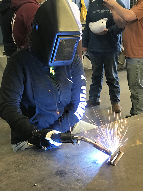 student in helmet welding
