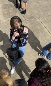 Reporter Tori Thorp photographs a student protestor attending a climate strike in front of the Albany, Ore. courthouse in September of 2019. Thorp's collection of audio and photo material at this event ended up as a radio story that was published on her school publication's YouTube channel and website.